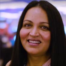 headshot of Titu Hariharan, a South Asian woman with tan skin and long dark hair